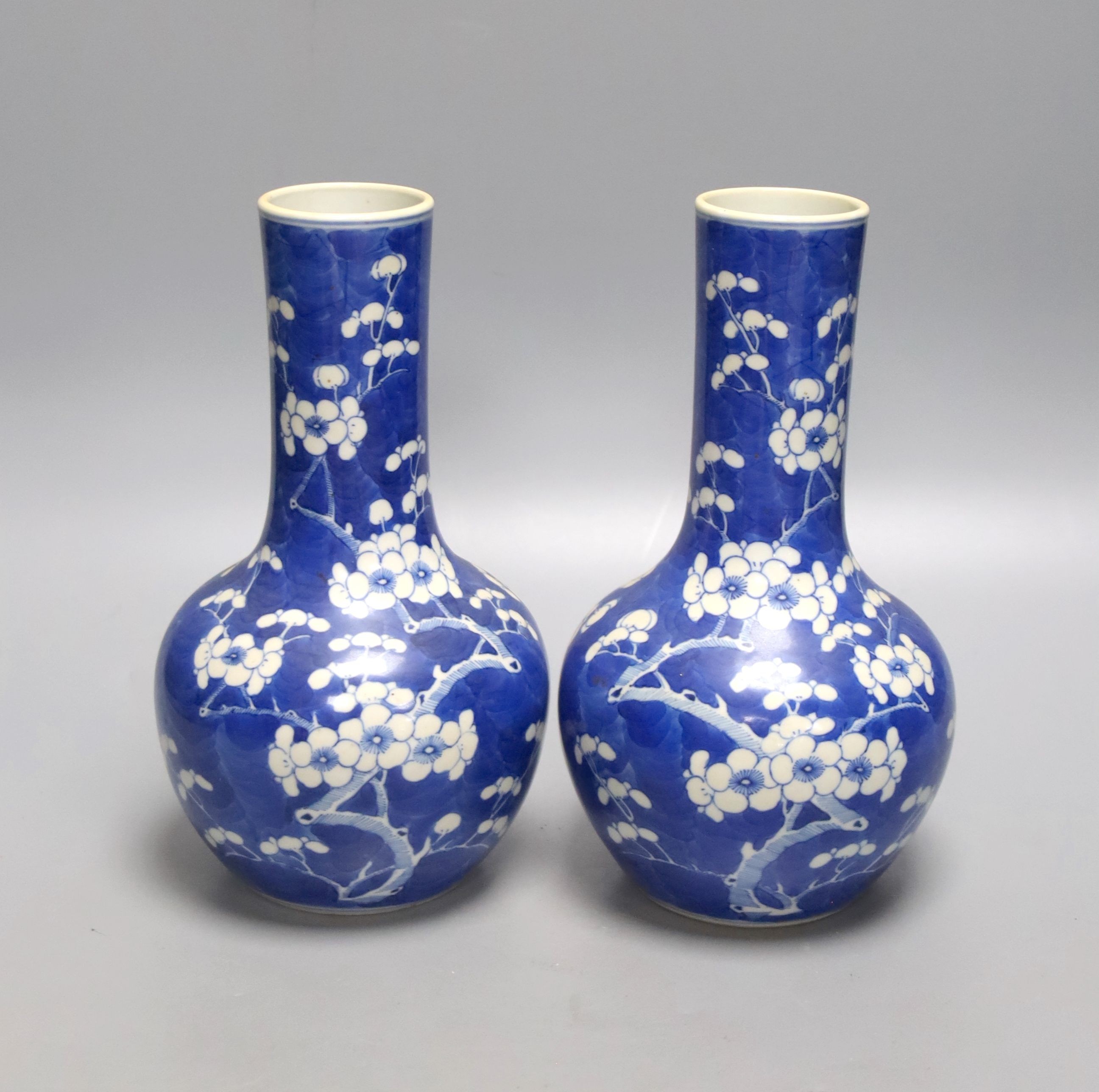 A pair of 19th century Chinese blue and white porcelain prunus vases, height 22cm